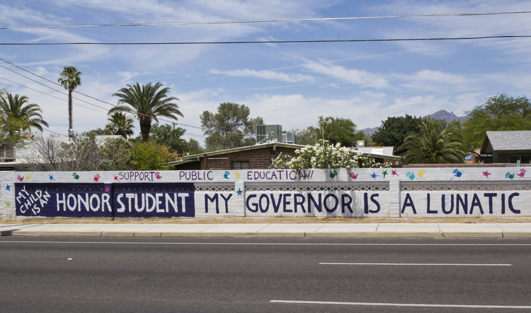 Peter Gattone and Joy Soler painted this message on their home's back wall, which borders East Broadway near Columbus Boulevard, in response to a decreased public education budget.