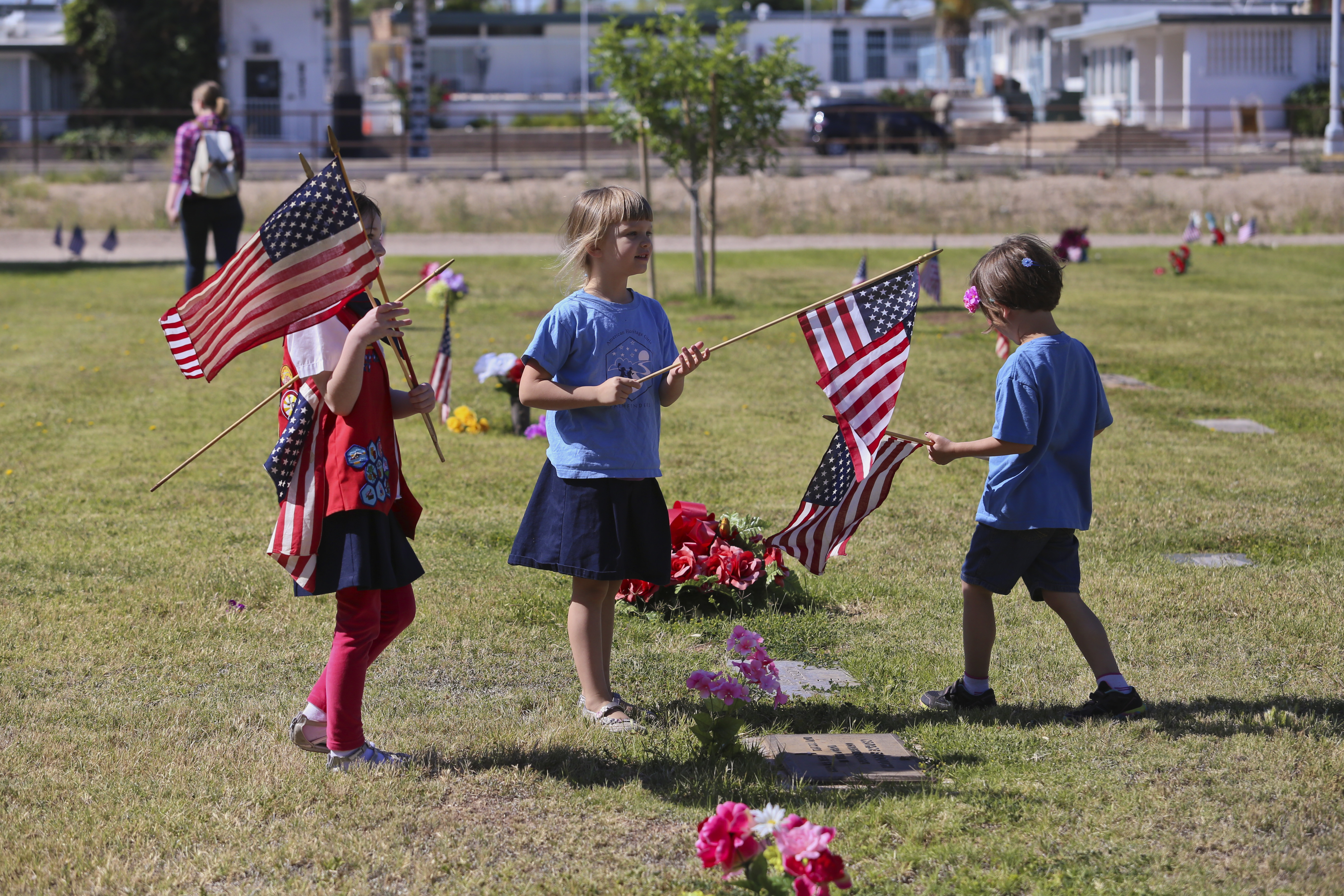 Scouts from the American Heritage Girls, a faith-based group, planted flags on veterans' graves across Evergreen Mortuary & Cemetery in observance of Memorial Day.