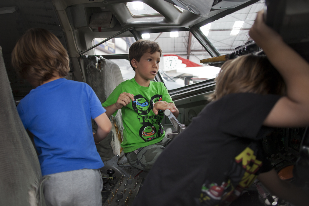 At the Pima Air & Space Museum in Tucson, siblings Sean, 5, left, Liam, 8, center, and Colin Burke, 5, played inside an airplane on May 27. The family, from San Francisco, is on a five-week road trip. P