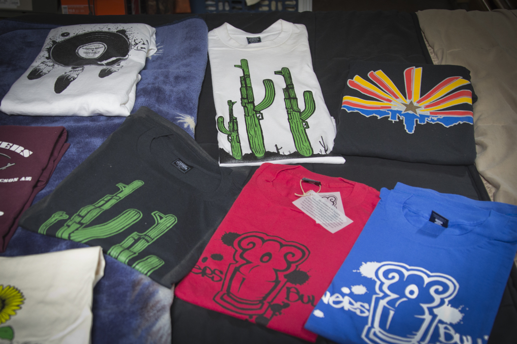 Shirts designed by graffiti artists with Flowers and Bullets are a source of income for the group.